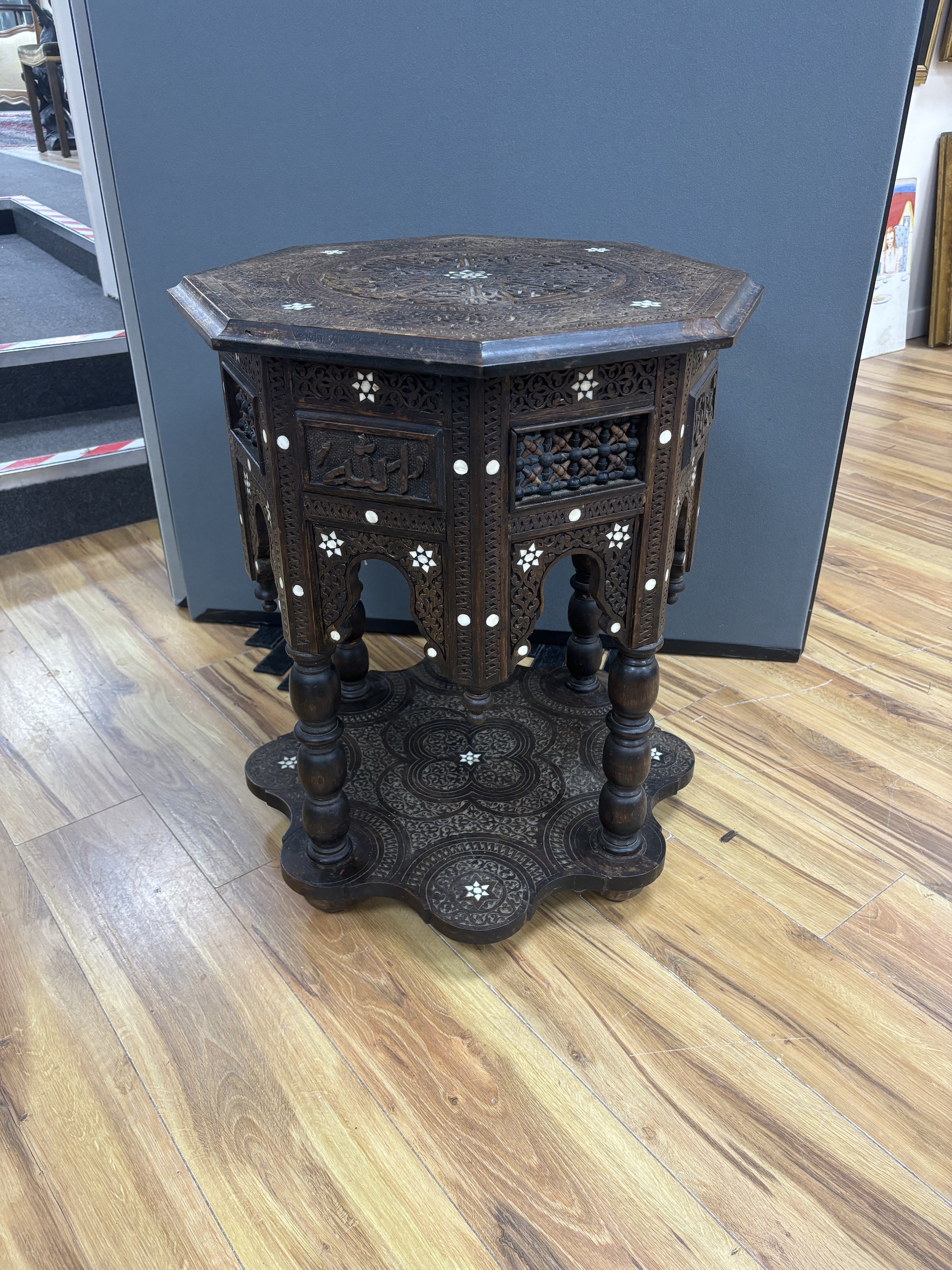 A Moroccan octagonal bone inlaid hardwood table, width 52cm, height 64cm